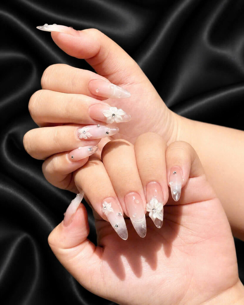 White French manicure on a black satin background