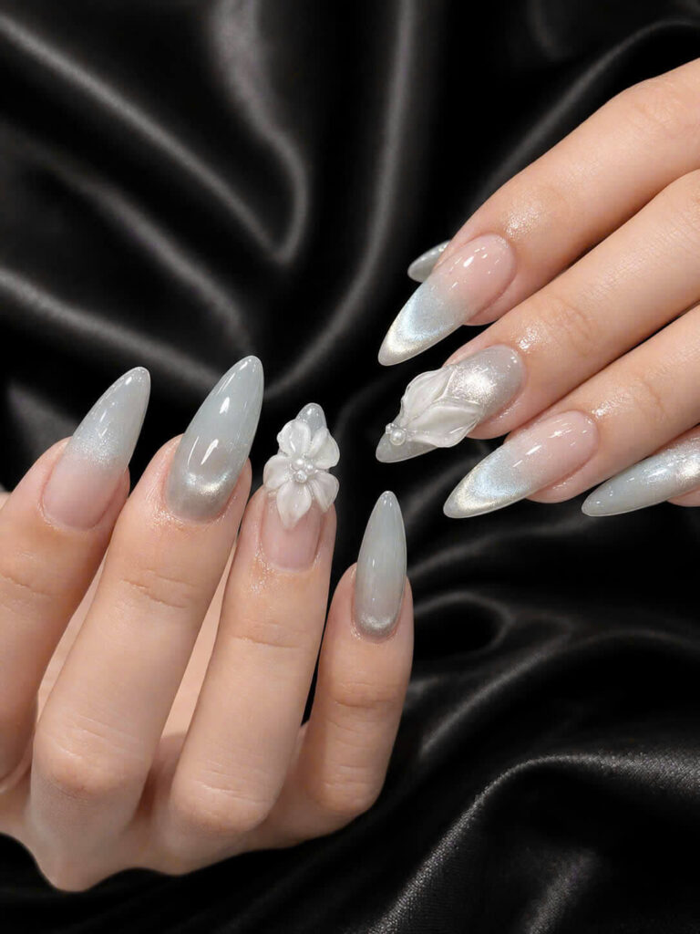 Pearl shimmer manicure on a black satin background