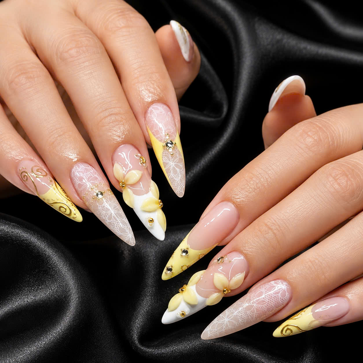 Yellow French tips with sculpted flowers and crystal accents on black silk