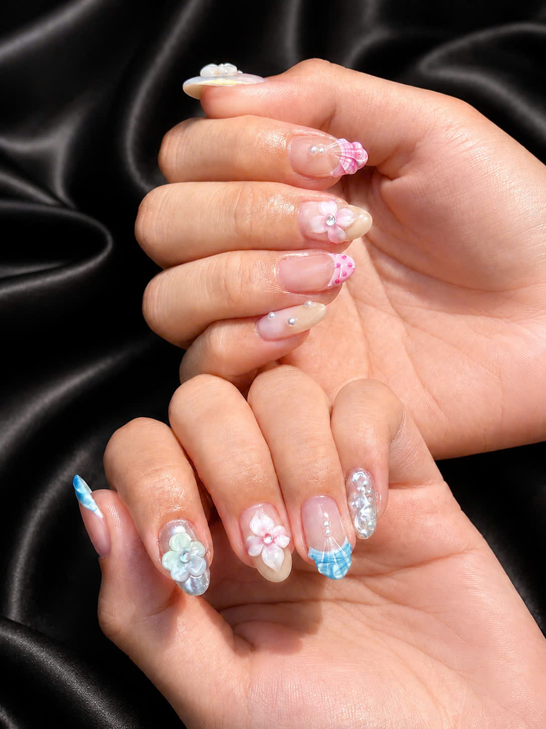 Pink and blue French tips with three-dimensional flowers on black silk